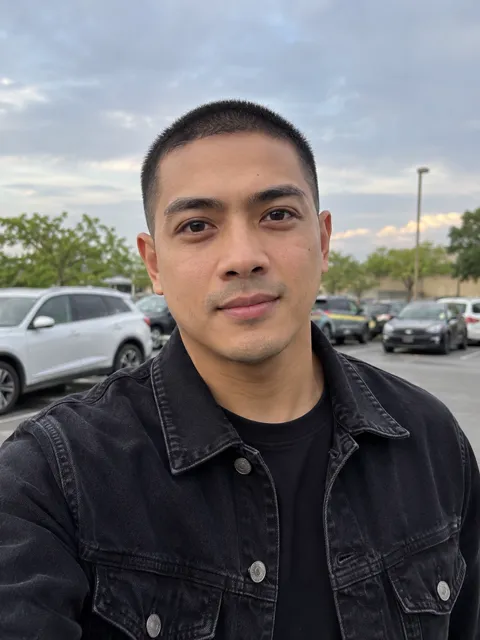 Photo of a Filipino man, early 30s, buzz cut, black denim jacket